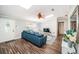 Inviting living room featuring a comfortable blue sectional sofa, skylights, and stylish decor at 455 Cypress Lake Ct, Oldsmar, FL 34677