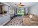 Inviting living area featuring a large window, comfortable seating, and hardwood floors at 455 Cypress Lake Ct, Oldsmar, FL 34677