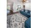 Spacious living room featuring a blue sofa, skylight, and view of the dining area and outdoor space at 455 Cypress Lake Ct, Oldsmar, FL 34677