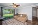 Inviting living area featuring a large window, comfortable seating, and hardwood floors at 455 Cypress Lake Ct, Oldsmar, FL 34677