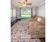 Bright living area featuring a large window, comfortable seating, and hardwood floors at 455 Cypress Lake Ct, Oldsmar, FL 34677