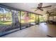 Enclosed patio with large tree in backyard at 455 Cypress Lake Ct, Oldsmar, FL 34677