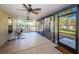 Inviting enclosed patio offering views of a spacious yard with seating at 455 Cypress Lake Ct, Oldsmar, FL 34677