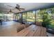 Inviting enclosed patio with dining set overlooking a lush, expansive backyard at 455 Cypress Lake Ct, Oldsmar, FL 34677