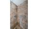 Close up of the shower featuring beige tiling, nice fixtures, and a mosaic tiled floor at 455 Cypress Lake Ct, Oldsmar, FL 34677