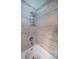 A close-up of the shower with tan tile at 455 Cypress Lake Ct, Oldsmar, FL 34677
