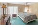 Carpeted bedroom with vintage wood furnishings, a ceiling fan, and window with curtains at 4609 10Th Street E Ct, Ellenton, FL 34222