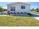 The home has a manicured lawn and a small brick garden, adding a touch of elegance at 4609 10Th Street E Ct, Ellenton, FL 34222