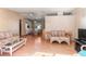 Cozy living room with wicker furniture flowing into a dining area with built-in cabinets at 4609 10Th Street E Ct, Ellenton, FL 34222