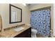 Bathroom with a granite countertop vanity and a shower/tub combo with a blue shower curtain at 5032 Cypress Trace Dr, Tampa, FL 33624