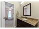 Bathroom featuring a granite countertop vanity, mirror, and views into an adjacent bedroom at 5032 Cypress Trace Dr, Tampa, FL 33624
