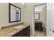 Bathroom featuring a granite countertop vanity with a sink, mirror, and an adjacent bathroom view at 5032 Cypress Trace Dr, Tampa, FL 33624