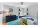 Well-lit bedroom with blue accents, wood floors, and a ceiling fan at 5032 Cypress Trace Dr, Tampa, FL 33624