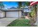 Inviting two-story home with blue siding, brick accents, and a well-manicured lawn at 5032 Cypress Trace Dr, Tampa, FL 33624