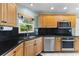 Well-lit kitchen features stainless steel appliances and sleek countertops, perfect for cooking at 5032 Cypress Trace Dr, Tampa, FL 33624