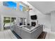 Spacious living room with a vaulted ceiling, fireplace, and sliding doors to the pool at 5032 Cypress Trace Dr, Tampa, FL 33624
