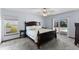 Bedroom with a dark wood bed frame, soft carpet, and a sliding glass door to the outdoor pool at 5032 Cypress Trace Dr, Tampa, FL 33624