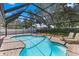 Inviting screened-in pool with a basketball hoop and brick-paved deck area at 5032 Cypress Trace Dr, Tampa, FL 33624