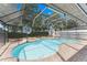 Inviting screened-in pool with a basketball hoop and brick-paved deck area at 5032 Cypress Trace Dr, Tampa, FL 33624