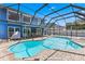 Inviting screened-in pool with a basketball hoop and brick-paved deck area at 5032 Cypress Trace Dr, Tampa, FL 33624