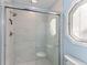 Contemporary shower with marble-patterned walls and a glass door at 5032 Cypress Trace Dr, Tampa, FL 33624