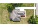 Birds-eye view of a well-maintained home with a screened-in pool and a long driveway at 5319 W Trapnell Rd, Dover, FL 33527