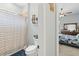 A view of a bathroom with a shower, toilet, and linen storage in the attached bedroom at 5319 W Trapnell Rd, Dover, FL 33527