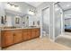 Spacious bathroom with dual sinks, wooden cabinets, and easy access to the bedroom at 5319 W Trapnell Rd, Dover, FL 33527