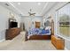 Large bedroom with a ceiling fan and a window overlooking the backyard at 5319 W Trapnell Rd, Dover, FL 33527