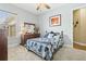 Bright bedroom with a ceiling fan, carpeted floor and natural light from the window at 5319 W Trapnell Rd, Dover, FL 33527