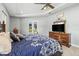 A spacious bedroom with a ceiling fan, outdoor access, and a decorative ceiling at 5319 W Trapnell Rd, Dover, FL 33527