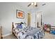 This is a well-decorated bedroom with a ceiling fan and easy access to the bathroom at 5319 W Trapnell Rd, Dover, FL 33527