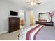 Bright bedroom with carpet flooring, ensuite bath, and dresser at 5319 W Trapnell Rd, Dover, FL 33527