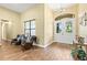 Inviting foyer with high ceilings, wood-look tile flooring, and decorative chandelier at 5319 W Trapnell Rd, Dover, FL 33527