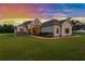 Charming single-story home featuring a lush lawn and a welcoming facade during sunset at 5319 W Trapnell Rd, Dover, FL 33527