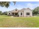 Charming single-story home featuring a lush lawn, decorative accents, and a welcoming facade at 5319 W Trapnell Rd, Dover, FL 33527