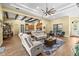 Spacious living room featuring wood beams, open floor plan, and comfortable seating at 5319 W Trapnell Rd, Dover, FL 33527