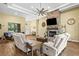 Bright living room with stone fireplace, ceiling fan, and open layout at 5319 W Trapnell Rd, Dover, FL 33527