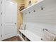 Functional mudroom with built-in bench, storage baskets, and shiplap wall detail at 5319 W Trapnell Rd, Dover, FL 33527