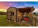 Quonset style shed with outdoor storage on a well-manicured lawn at 5319 W Trapnell Rd, Dover, FL 33527