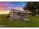 Quonset style shed with plank ramp on a well-manicured lawn at 5319 W Trapnell Rd, Dover, FL 33527