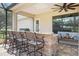 Covered outdoor kitchen features granite countertops and bar seating, creating an ideal entertainment space at 5319 W Trapnell Rd, Dover, FL 33527