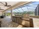 Covered outdoor kitchen complete with a grill, sink, and storage, perfect for entertaining at 5319 W Trapnell Rd, Dover, FL 33527
