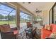 Screened outdoor patio perfect for entertaining, with ample seating and ceiling fans at 5319 W Trapnell Rd, Dover, FL 33527
