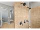 A spacious shower with a tiled wall and multiple shower heads with adjacent toilet area at 5319 W Trapnell Rd, Dover, FL 33527