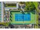 Aerial view of a community tennis court, recreational area, and parking, showcasing outdoor amenities at 6020 S Shore Blvd # 709, Gulfport, FL 33707