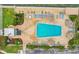 Aerial view of a sparkling pool, lounge chairs, and lush landscaping, creating a relaxing oasis at 6020 S Shore Blvd # 709, Gulfport, FL 33707