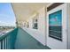 Balcony with railing, door to unit 709, and long corridor, with a water view in the distance at 6020 S Shore Blvd # 709, Gulfport, FL 33707