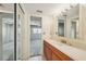 Bathroom vanity with mirror, sliding doors, and neutral tiling at 6020 S Shore Blvd # 709, Gulfport, FL 33707