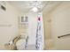 Compact bathroom with a shower featuring grab bars and shower curtain at 6020 S Shore Blvd # 709, Gulfport, FL 33707
